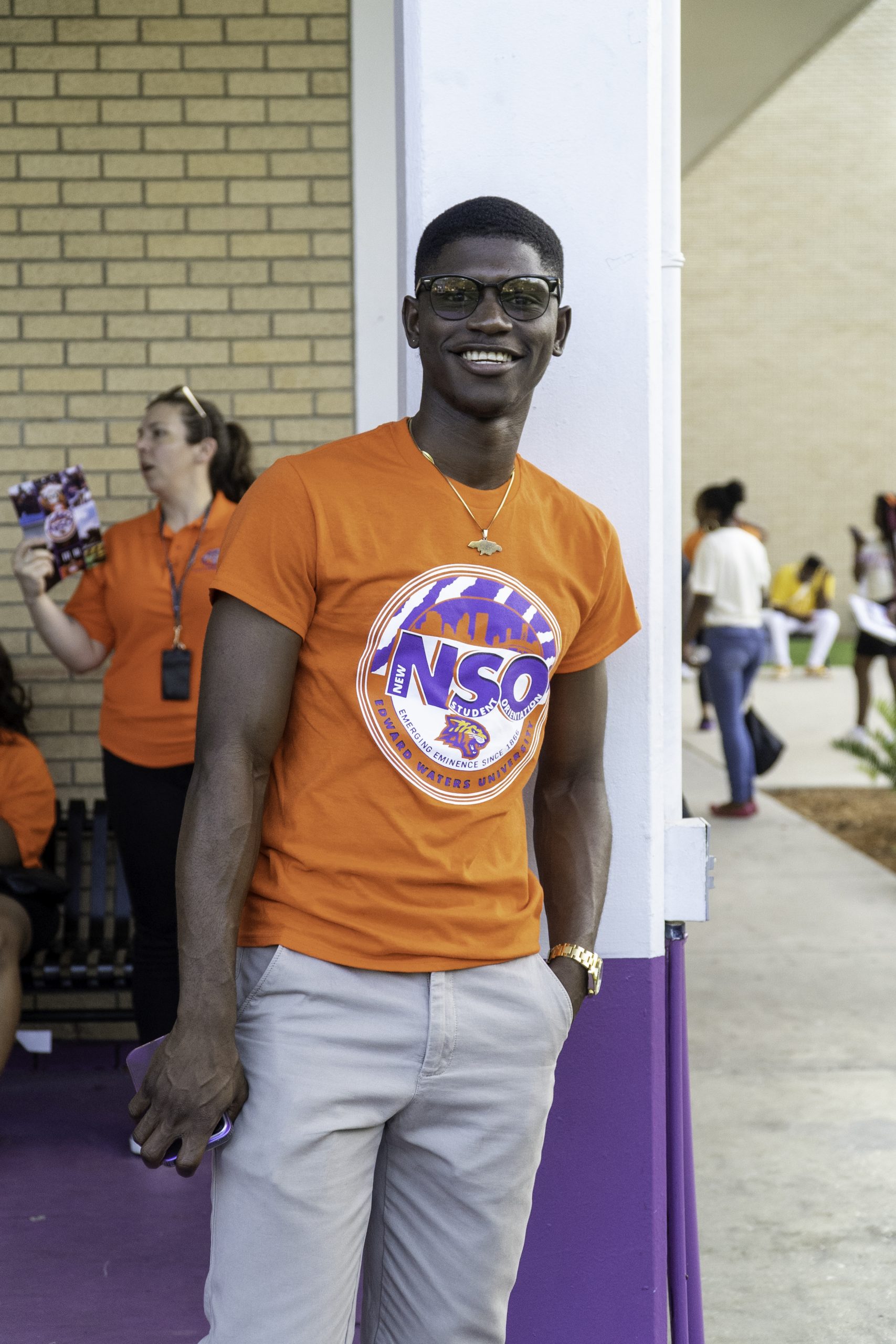 Male student smiling wearing glasses